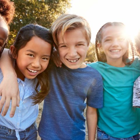 Portrait Of Multi-Cultural Children Hanging Out With Friends In