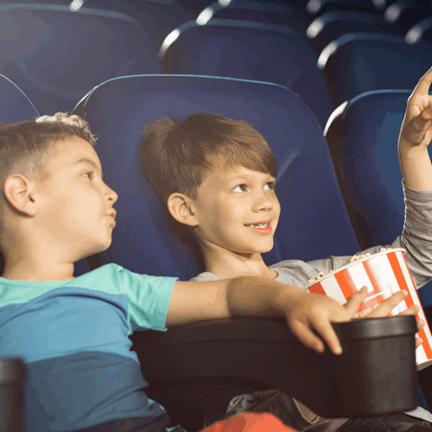two children watching a movie